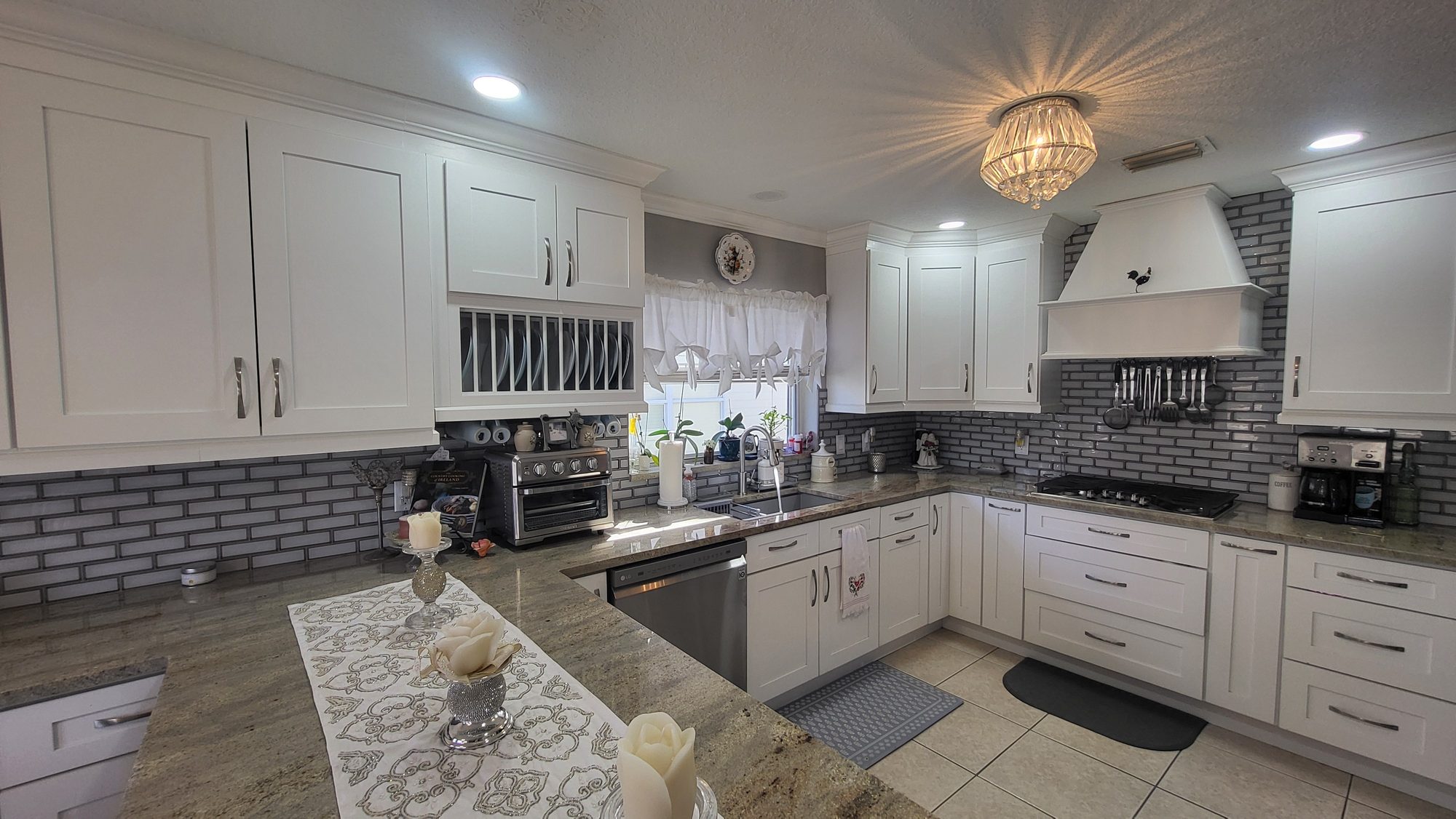 White Kitchen with Tile Backsplash and Range Hood