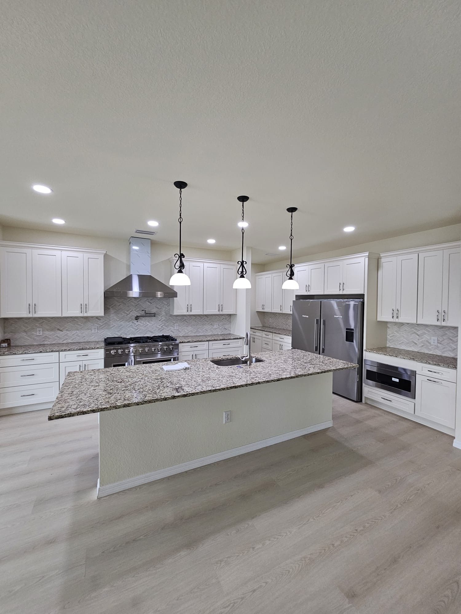 White Kitchen with Island and Pendants