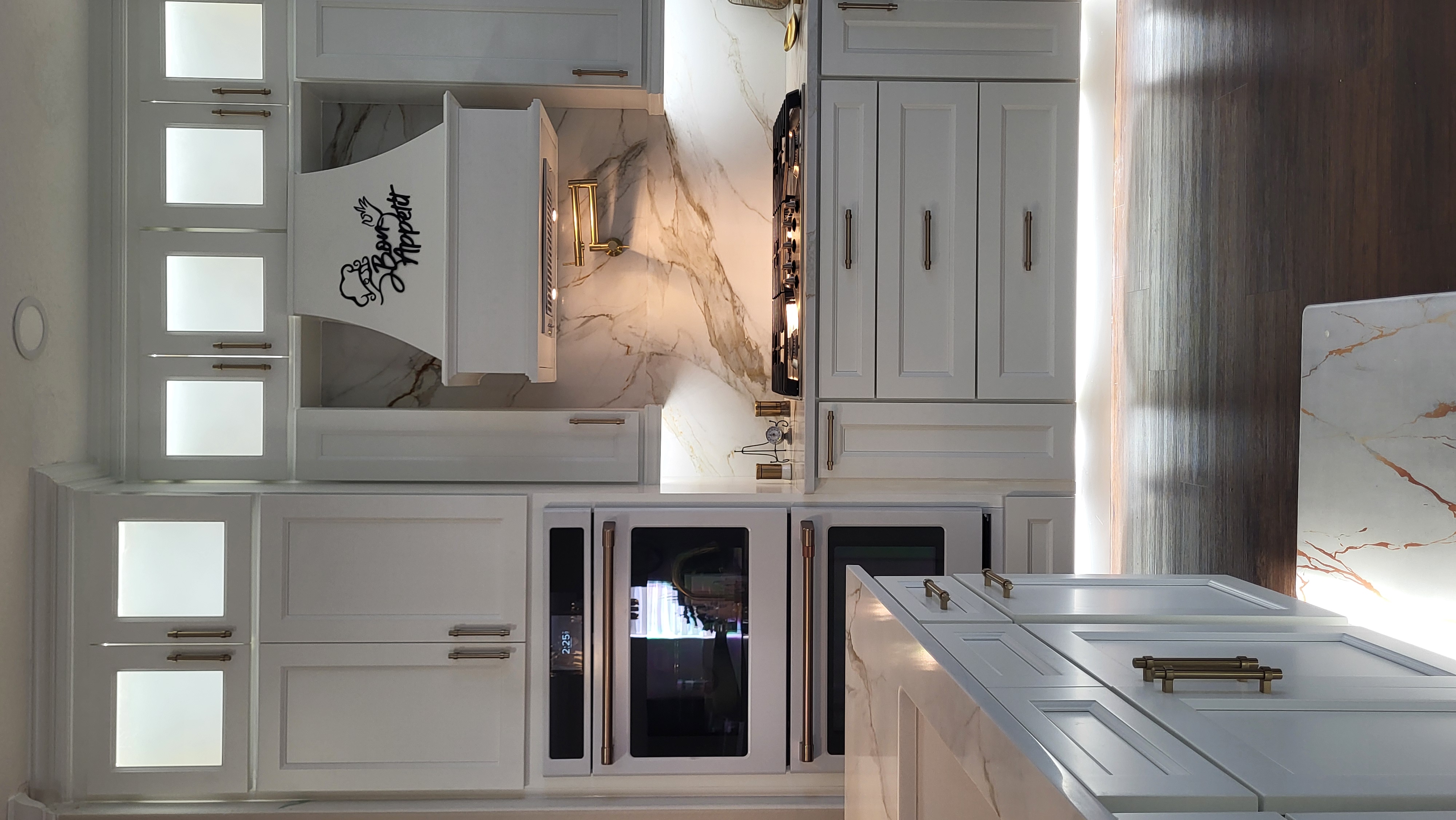 Marble and brass kitchen with hood