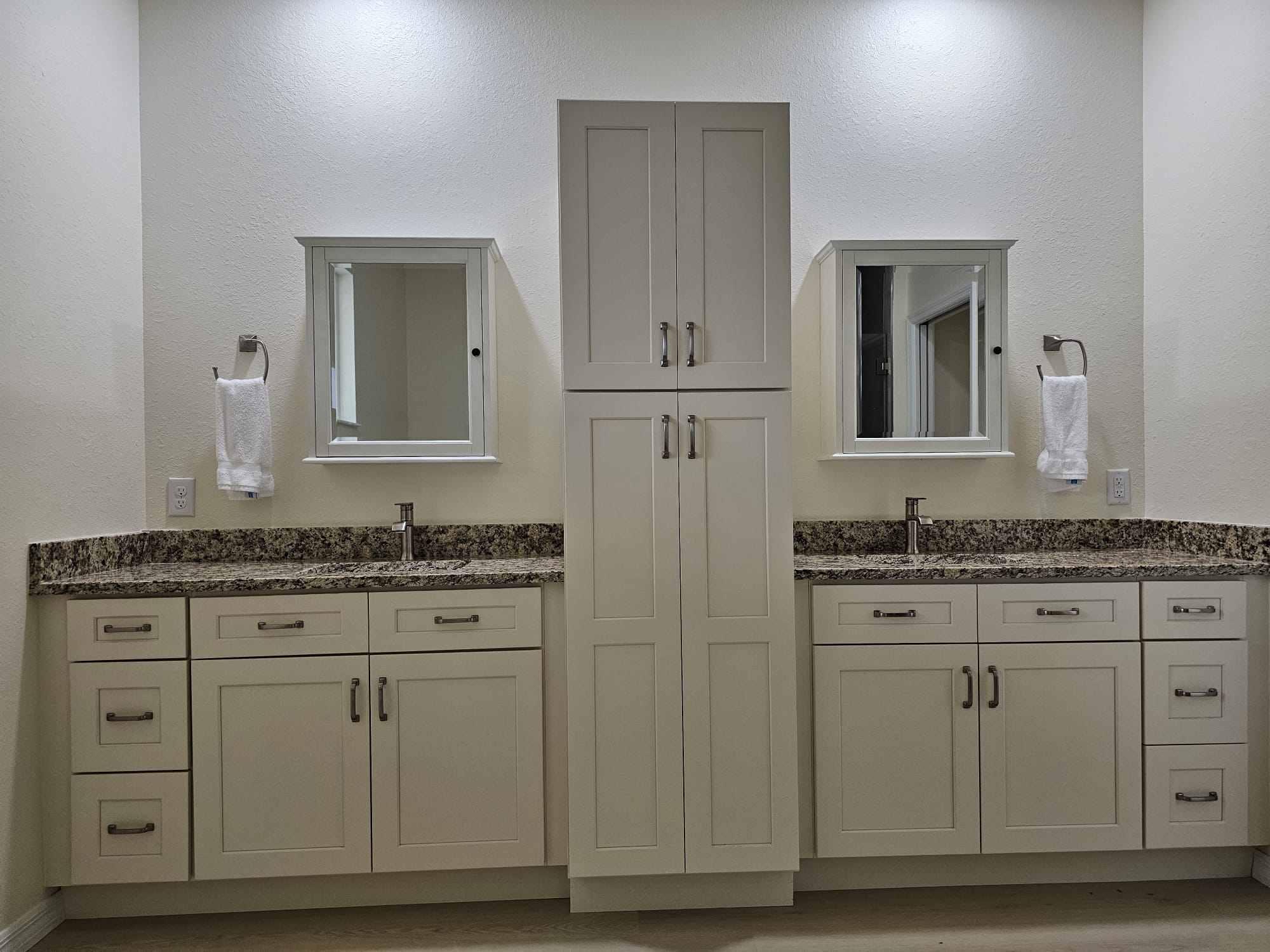 Cream shaker bathroom vanity with a matching tower cabinet