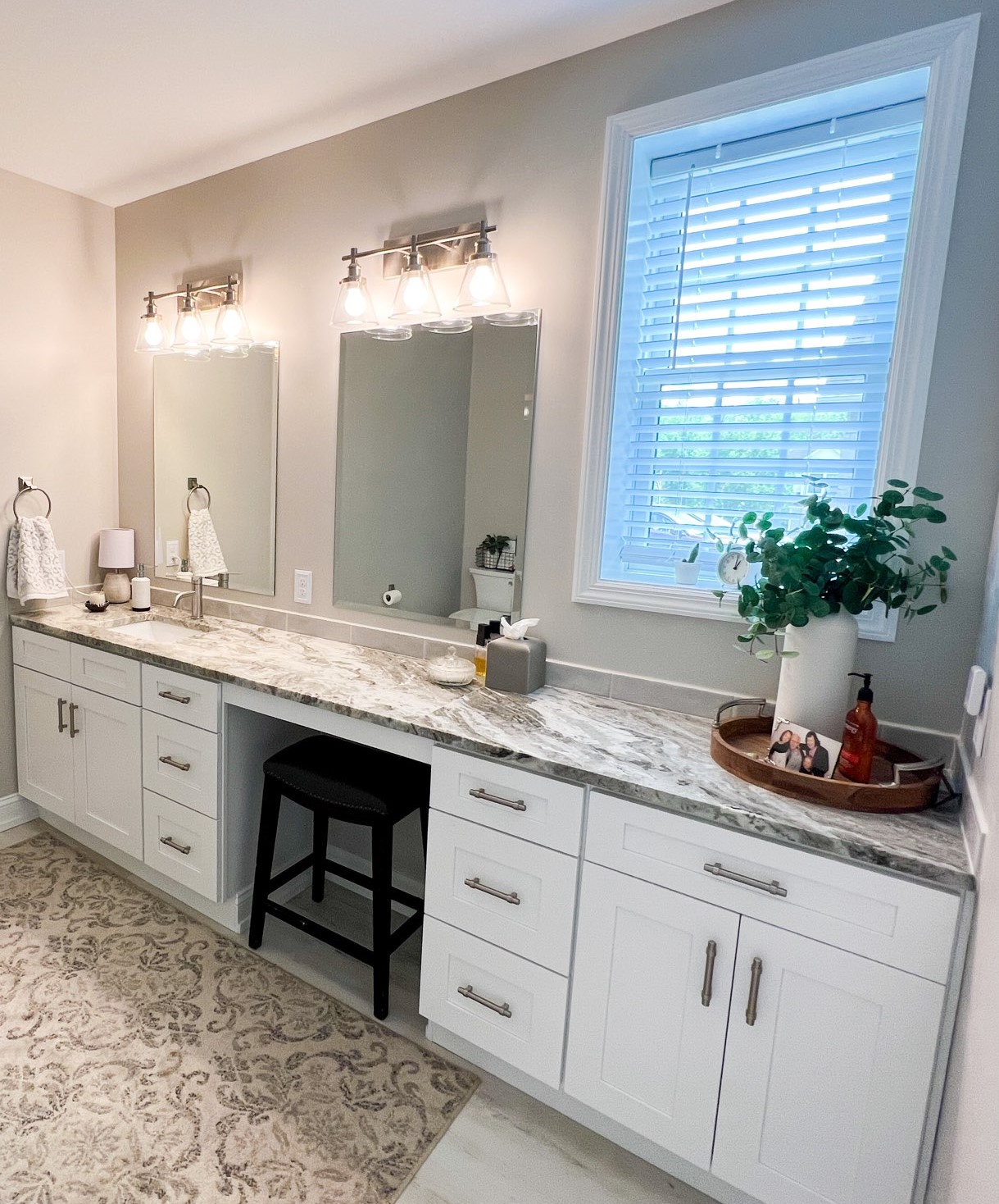 White shaker double vanity with makeup station and marble top