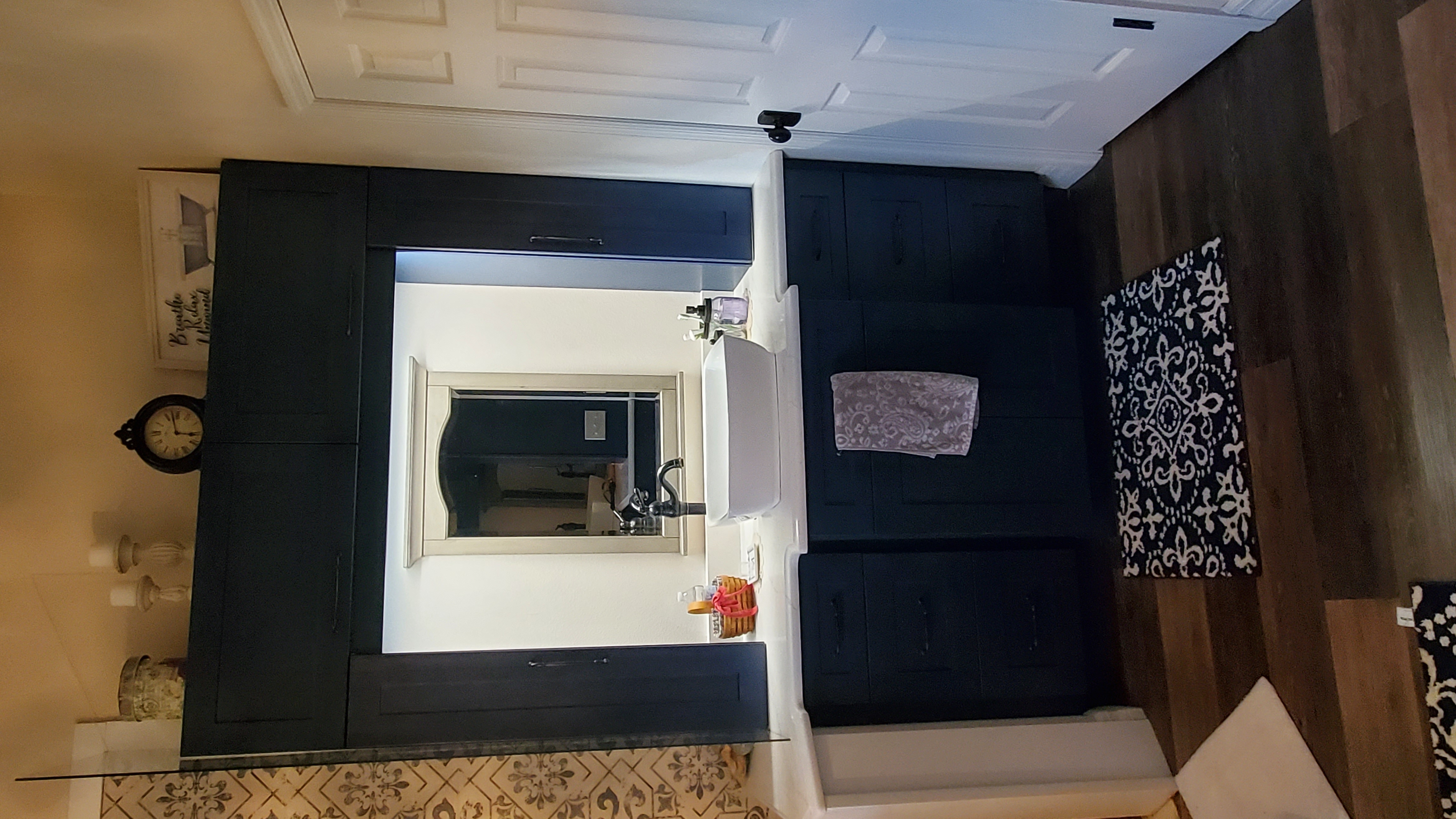 Navy shaker vanity with vessel sink and decorative tile